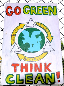 Hand-painted sign by Paul Cuffee students remind us of our responsibility to keep the land and waterways clean.