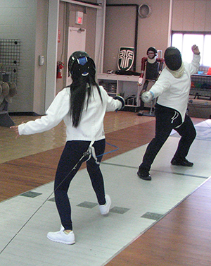 Students lunge and parry during a fencing exercise reminiscent of the climactic fight in Shakespeare’s Hamlet.