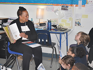 Financial professional reads to 4th graders during Reading Week